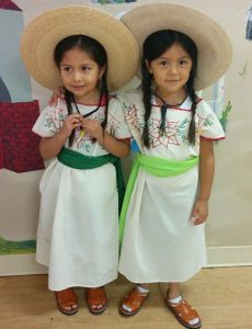 Two young members of Ballet Folklorico Tierra Caliente prepare for their upcoming La Pastorela. 