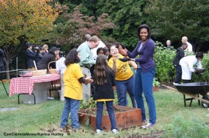 First Lady Michelle Obama in a community garden harvesting vegetables. Photo by Karina Hurley