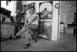 Natalia Bautista in her home in Santa Maria, surrounded by paintings by Mexican muralist Diego Rivera. 