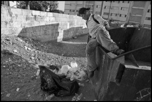 TIJUANA, BAJA CALIFORNIA NORTE, MEXICO - 9SEPTEMBER14 - Luisa, a homeless woman, collects cans and plastic from garbage dumpsters, near the Tijuana River, in downtown Tijuana, not far from the U.S. Mexico border.  Copyright David Bacon