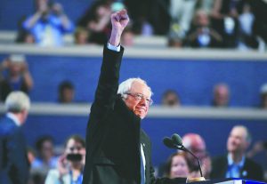 Former Democratic presidential candidate Senator Bernie Sanders raises his fist as he takes the podium at the Democratic National Convention in Philadelphia, Pennsylvania